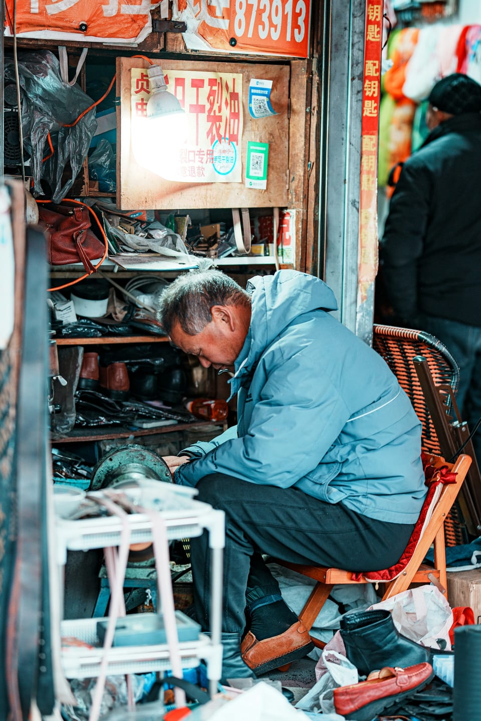 Cobbler working over a shoe repair bench