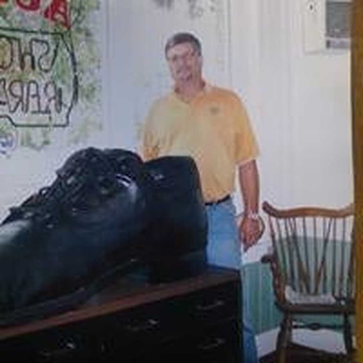 Repaired black shoe at a repair counter