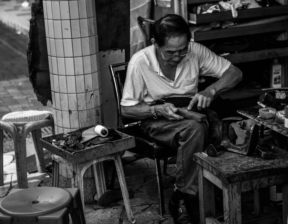 Shoe shine work at a small repair stand